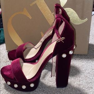 Red velvet platform pumps with pearl accent